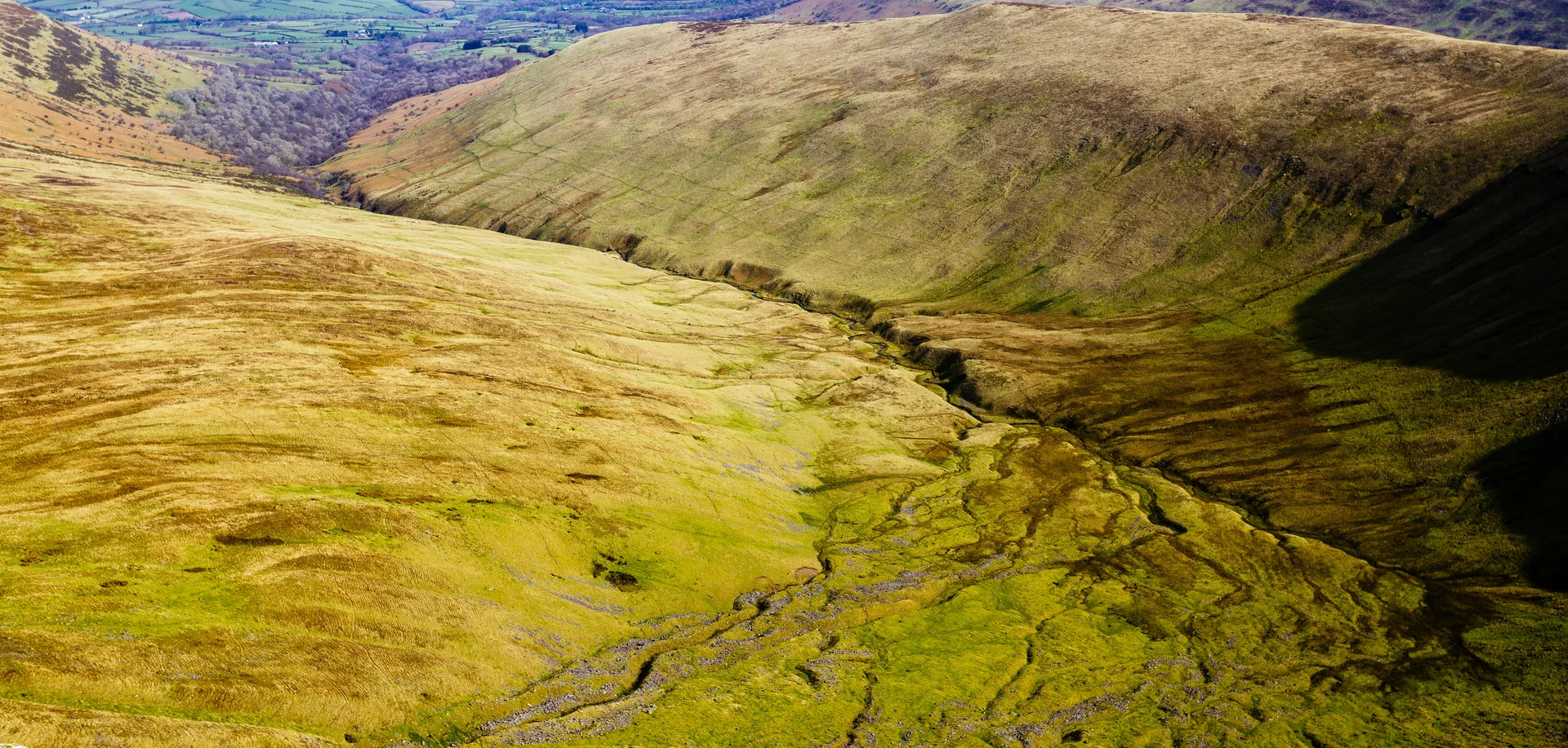 Aerial view of a valley climbing toward the northern ridge above Cwm Gwdi