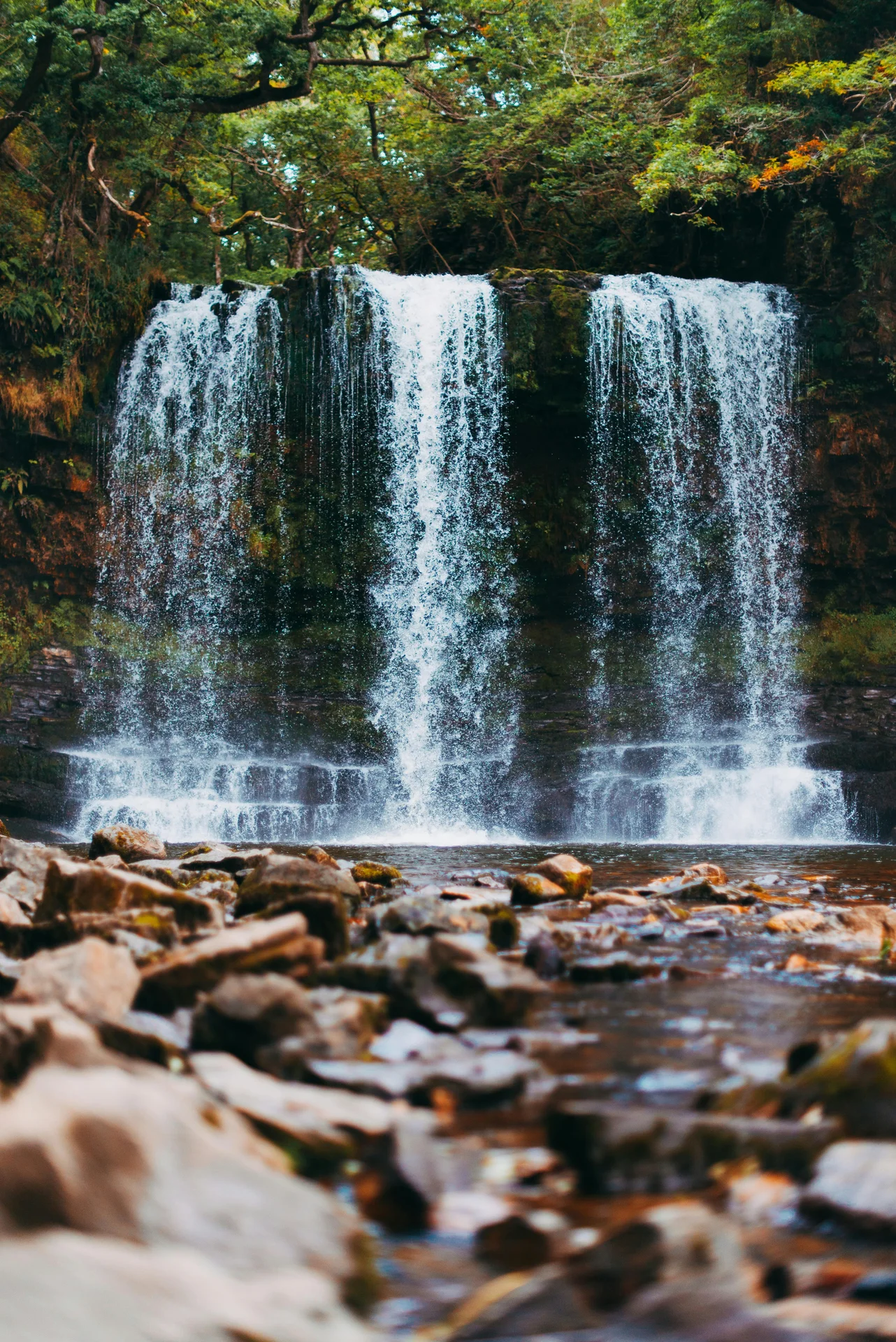 A wide curtain waterfall in Waterfall Country that walkers can pass behind