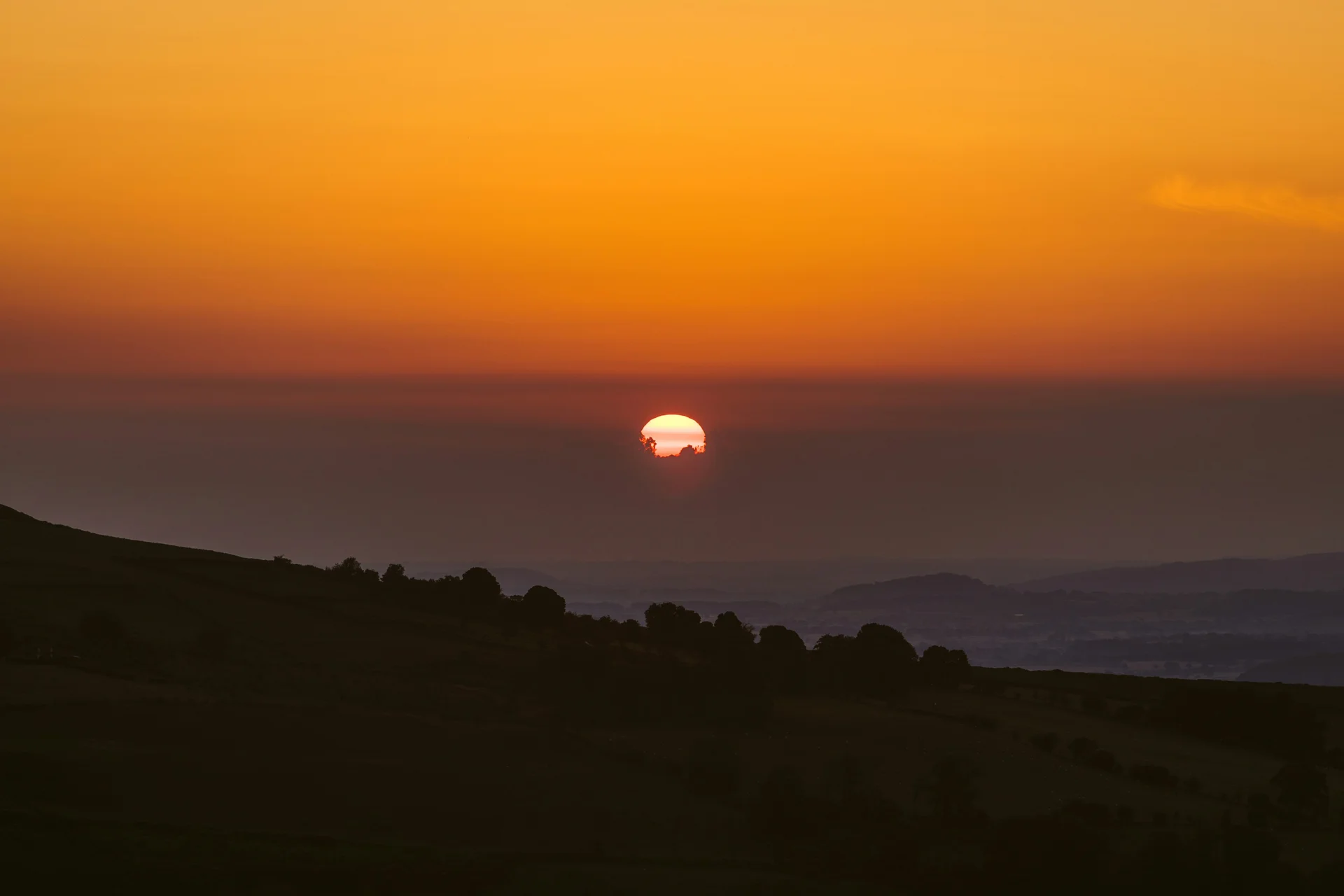 Silhouetted ridgeline of the Brecon Beacons at sunset