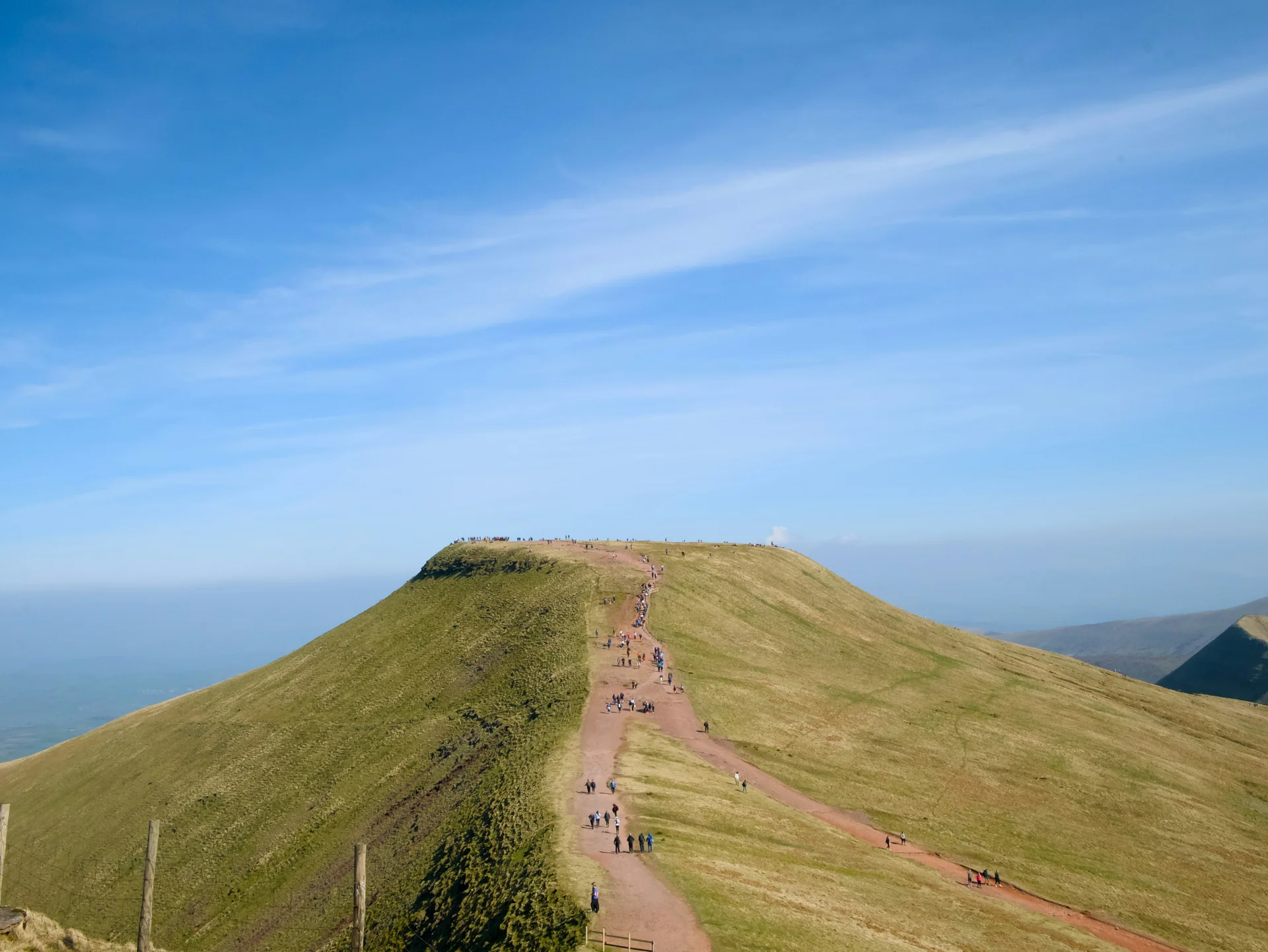 Walkers on the ridge path to Pen y Fan summit on a sunny day