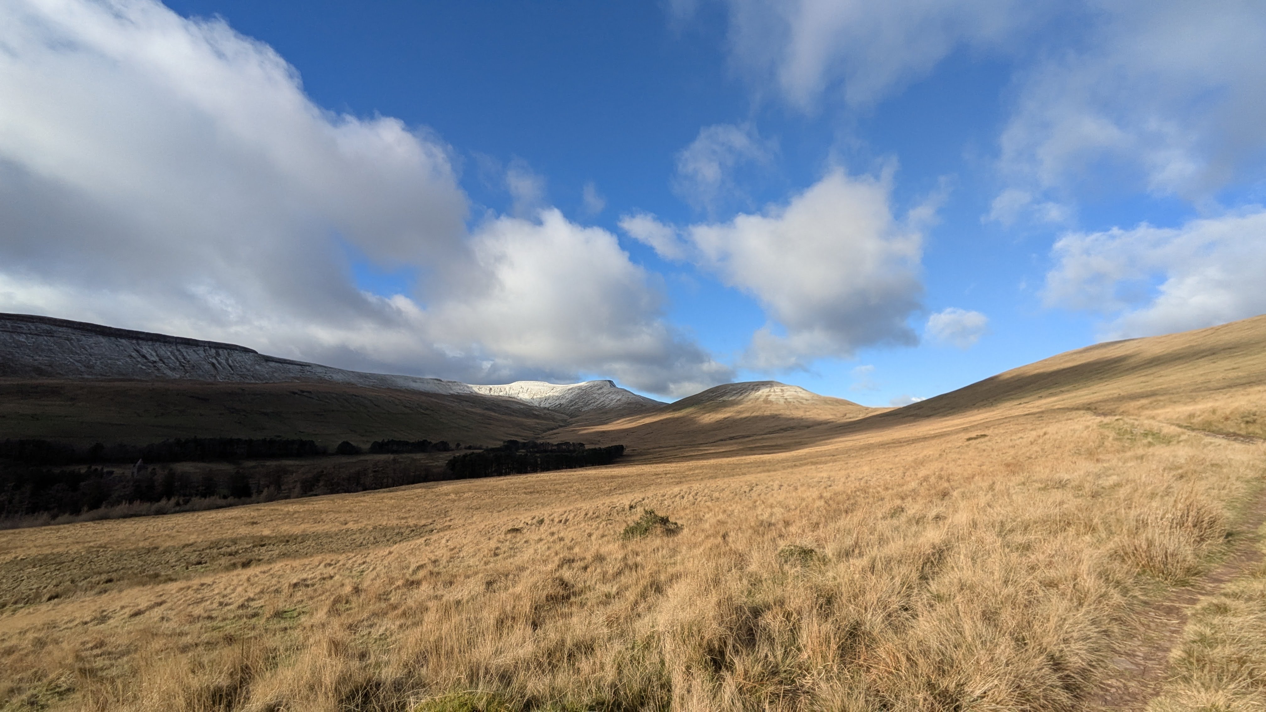 Wide golden moorland leading to Pen y Fan and Corn Du with a dusting of snow